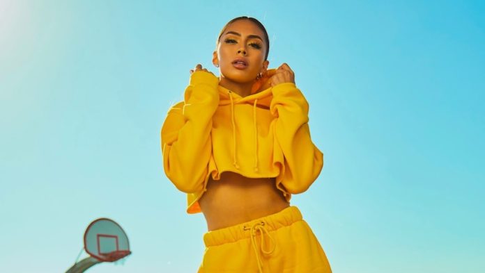 woman in yellow tracksuit standing on basketball court side