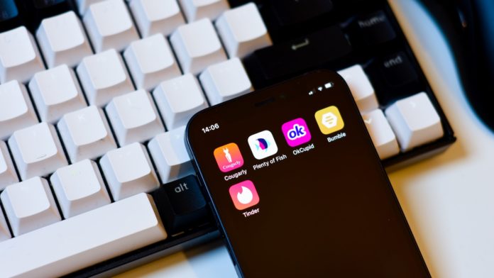 a cell phone sitting next to a keyboard