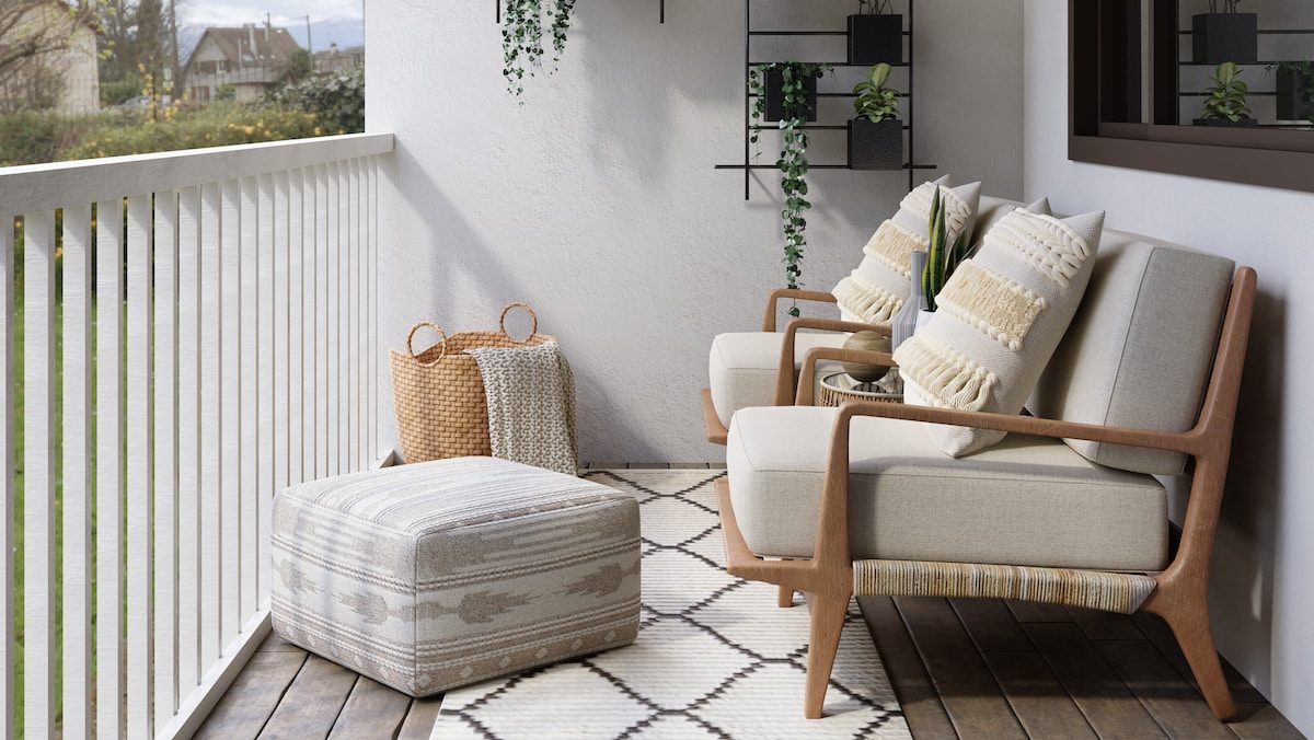 2 brown wooden armchairs beside white wall