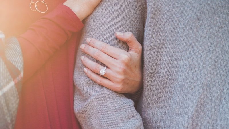 woman holding the shoulder of man