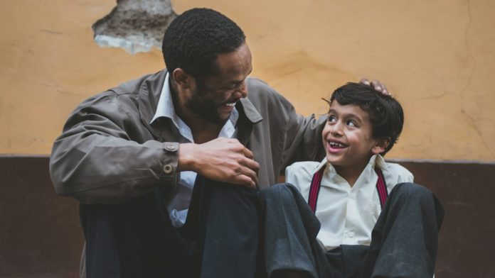 man holding boy's head