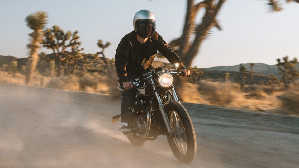 man in black jacket riding motorcycle on road during daytime