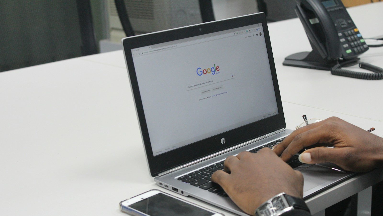 person typing on gray and black HP laptop