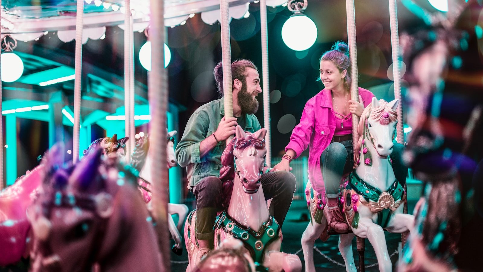 man and woman riding a carousel