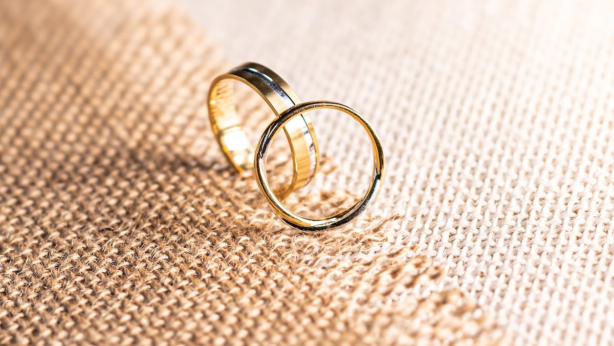 silver ring on brown textile
