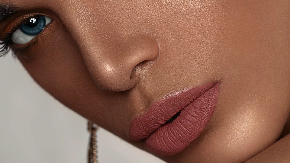 woman with red lipstick and gold hoop earrings