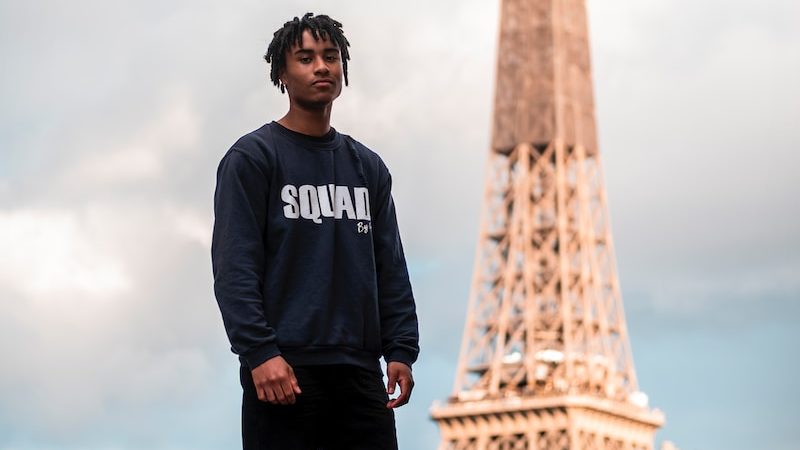 a man standing in front of the eiffel tower