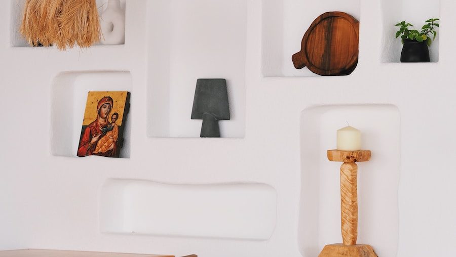 a white wall with a wooden table and chairs