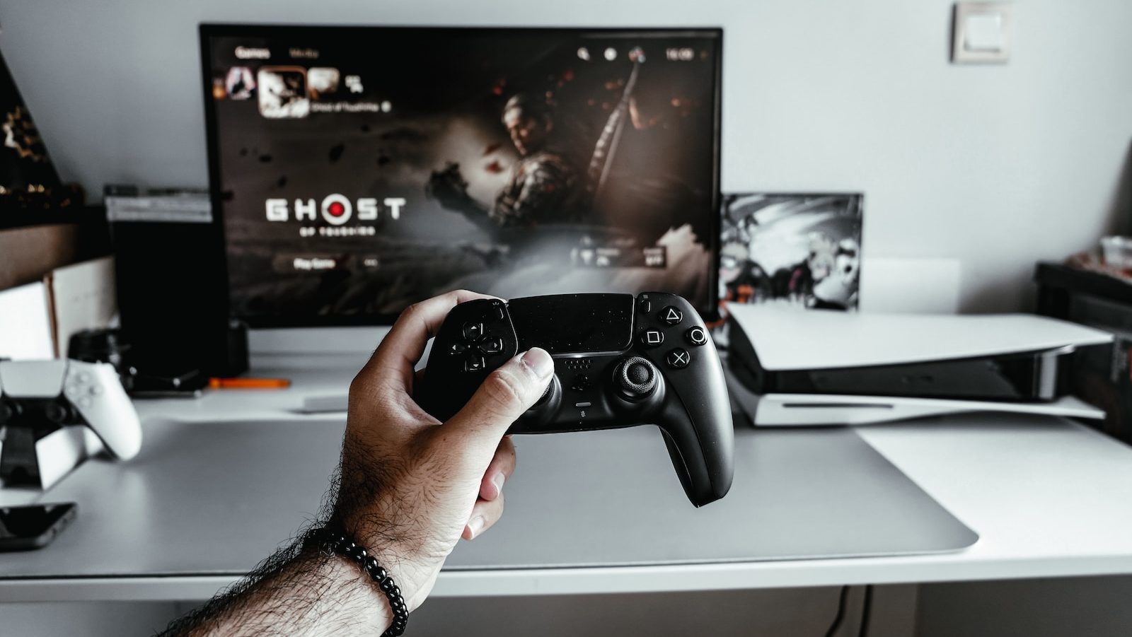 a person holding a video game controller in front of a tv