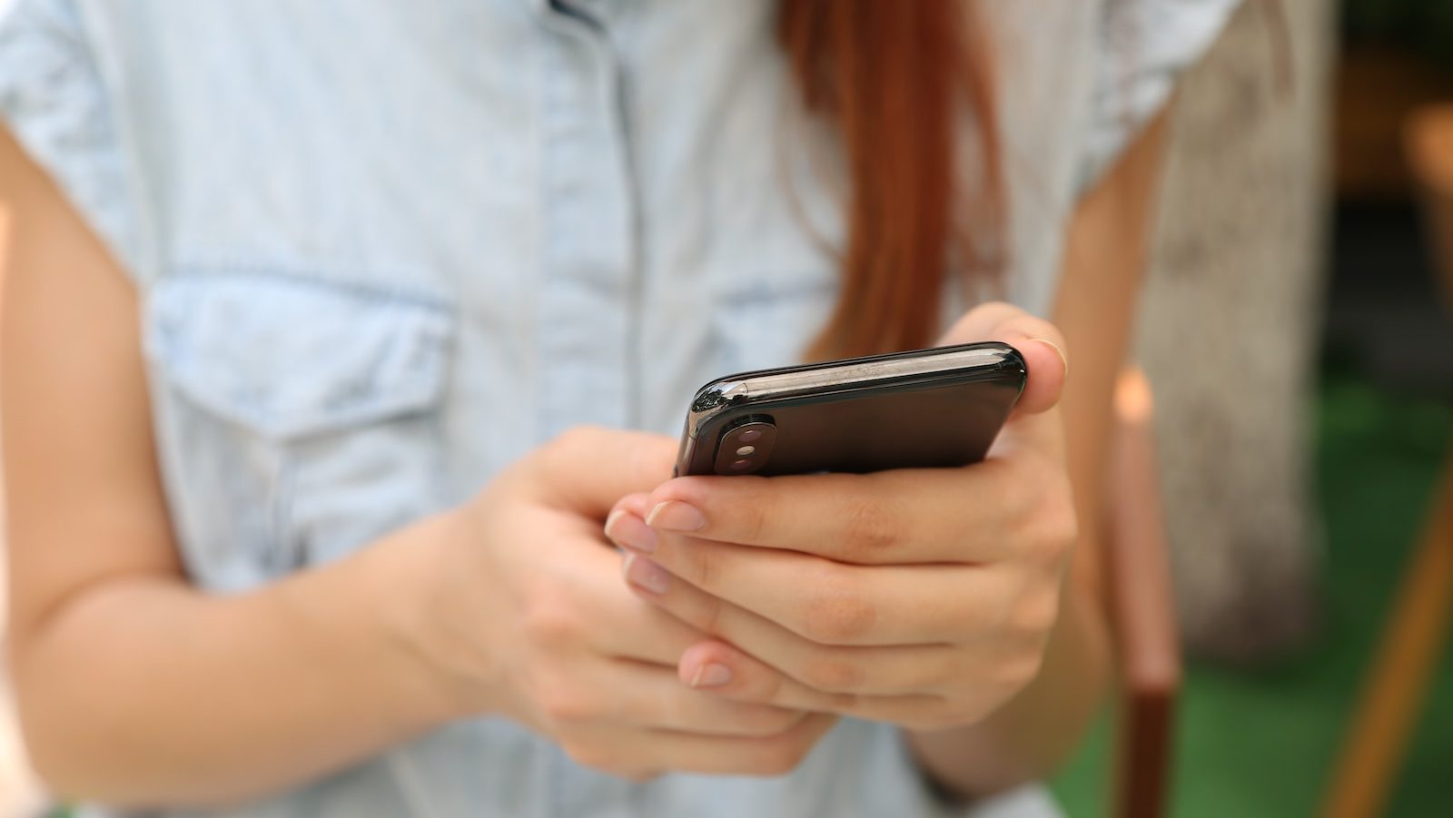 person holding using iPhone X