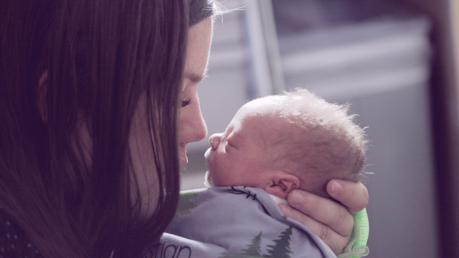 woman kissing baby