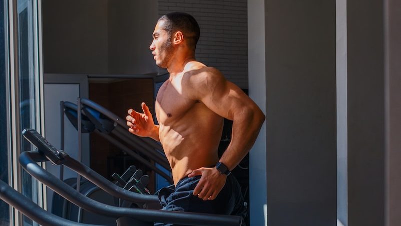 a man running on a treadmill in a gym