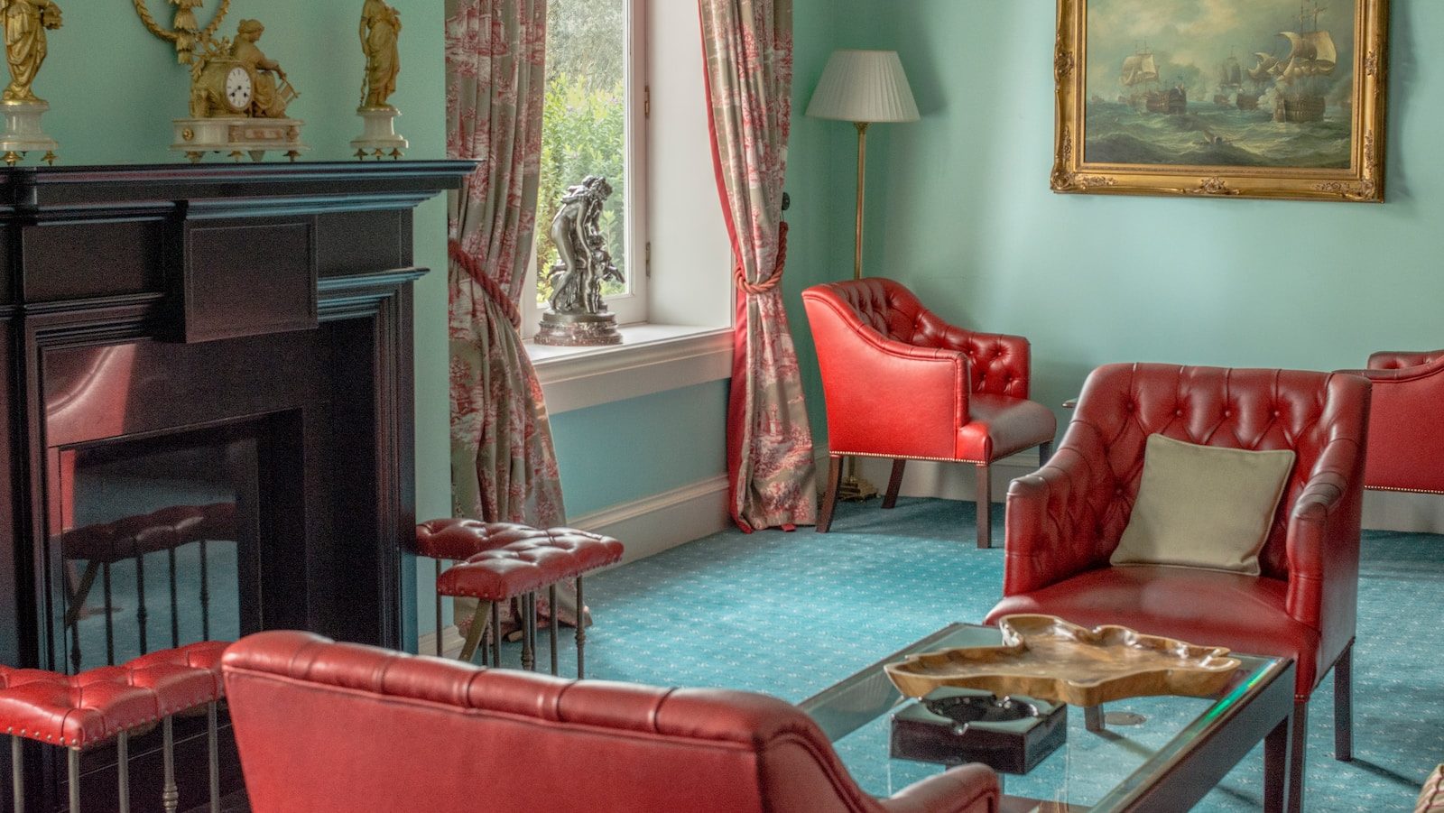 red sofa chair near fireplace